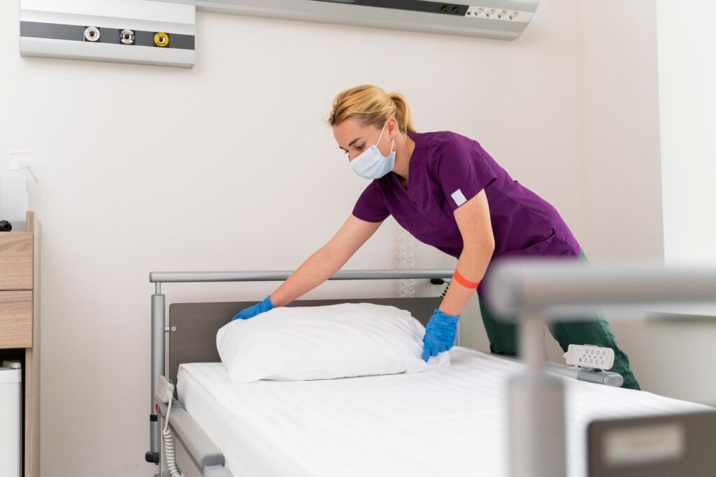 Essential cleaning supplies for maintaining a home hospital bed including microfiber cloths, disinfectant, and vacuum cleaner