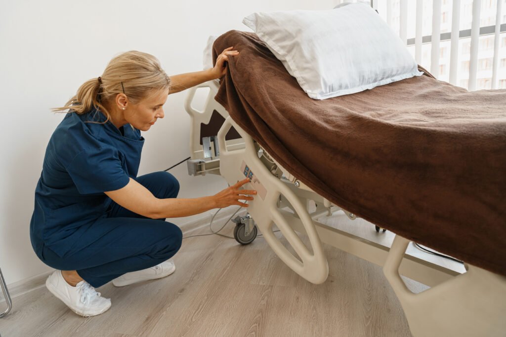 Medical nurse preparing hospital ward bed with pillow and blanket for comfort of sick person